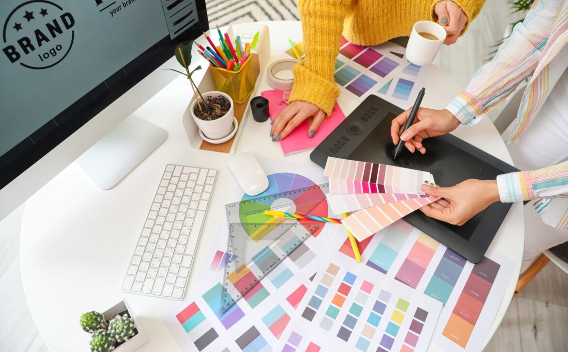 Graphic designer with colleague working in office
