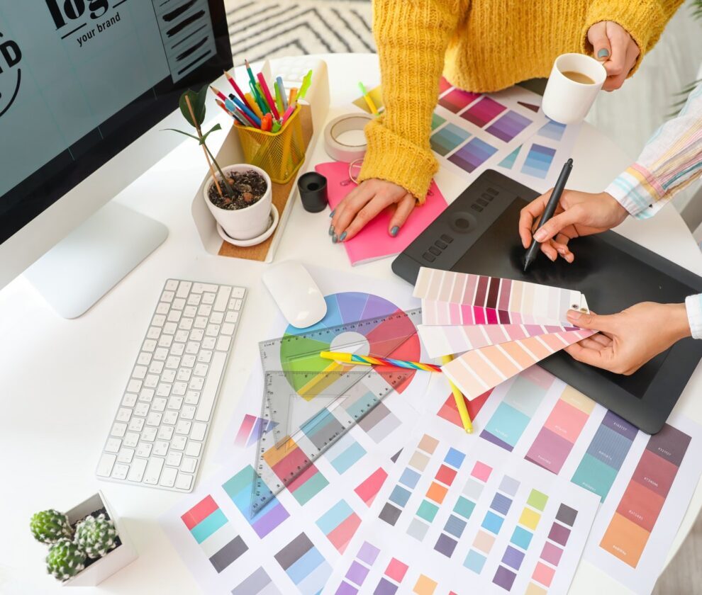Graphic designer with colleague working in office